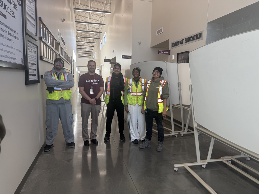 Mr. Jason Schapmann with representatives from Amazon as he accepts a donation of 10 rolling large whiteboards from Amazon.