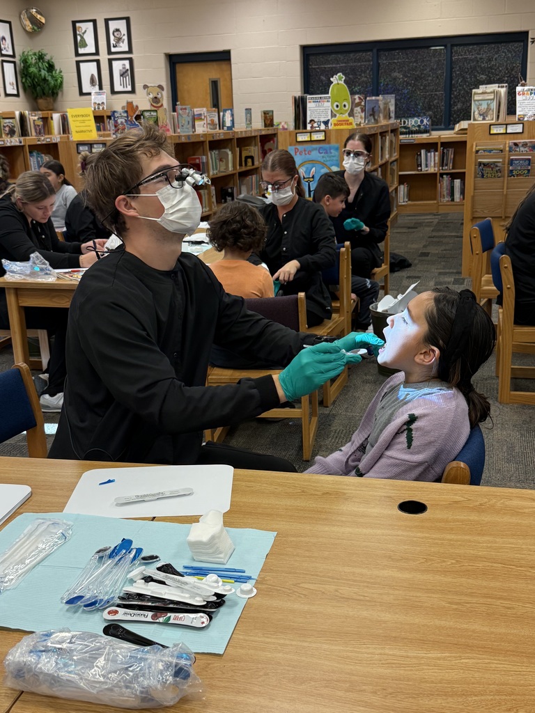 Dental hygiene student assessing a student