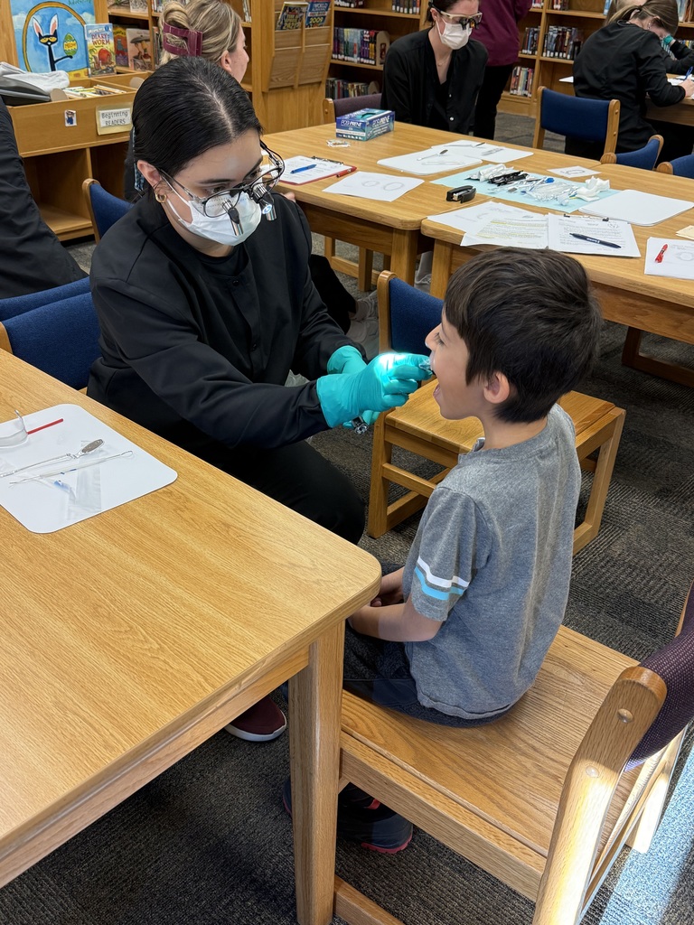 Dental hygiene student assessing a student