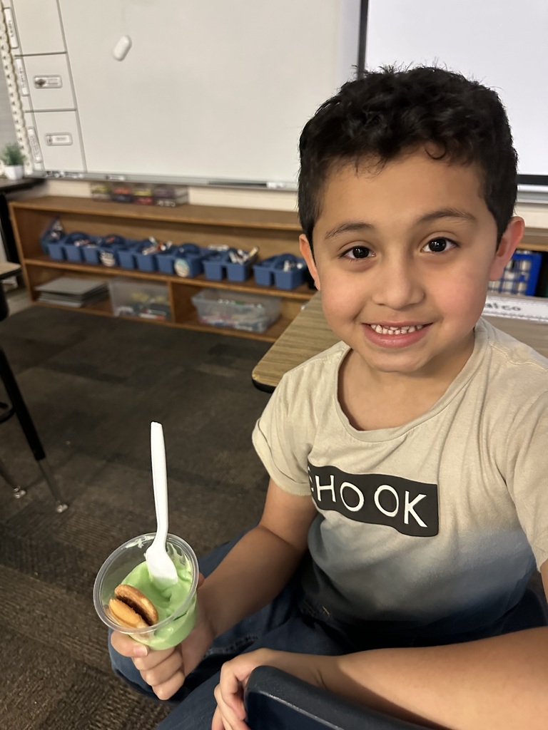 a student is holding a green pudding cup