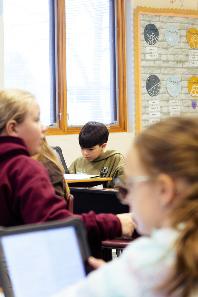 students completing projects on their ipads during class