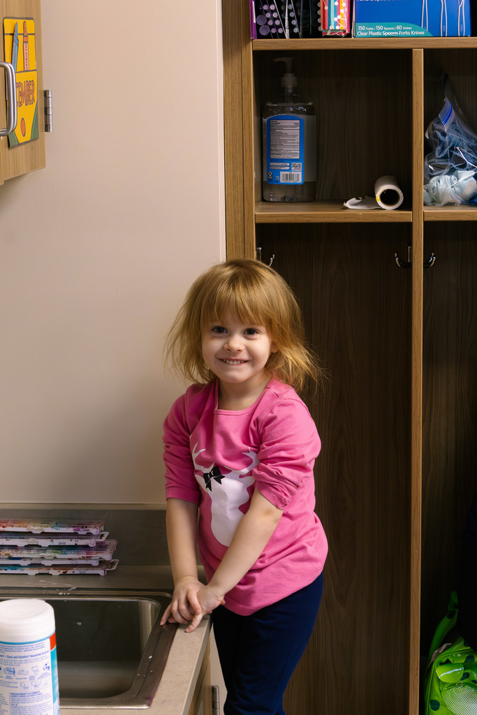 female student getting ready to wash hands