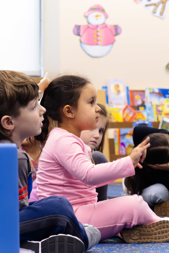 students participating in group time doing dancing actions