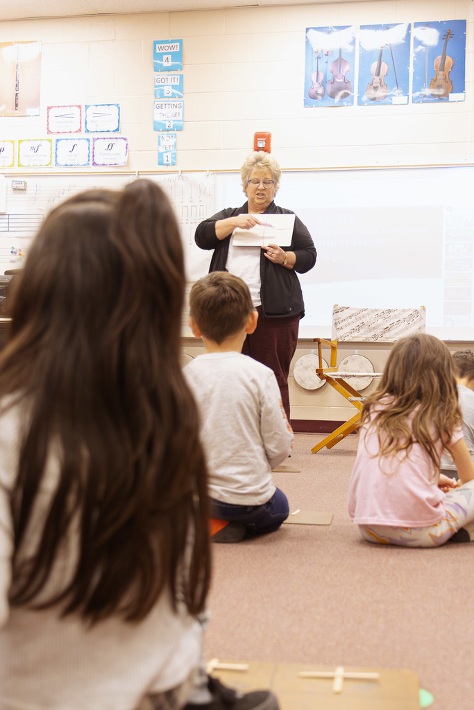 music teacher delivering a lesson to students in her classroom