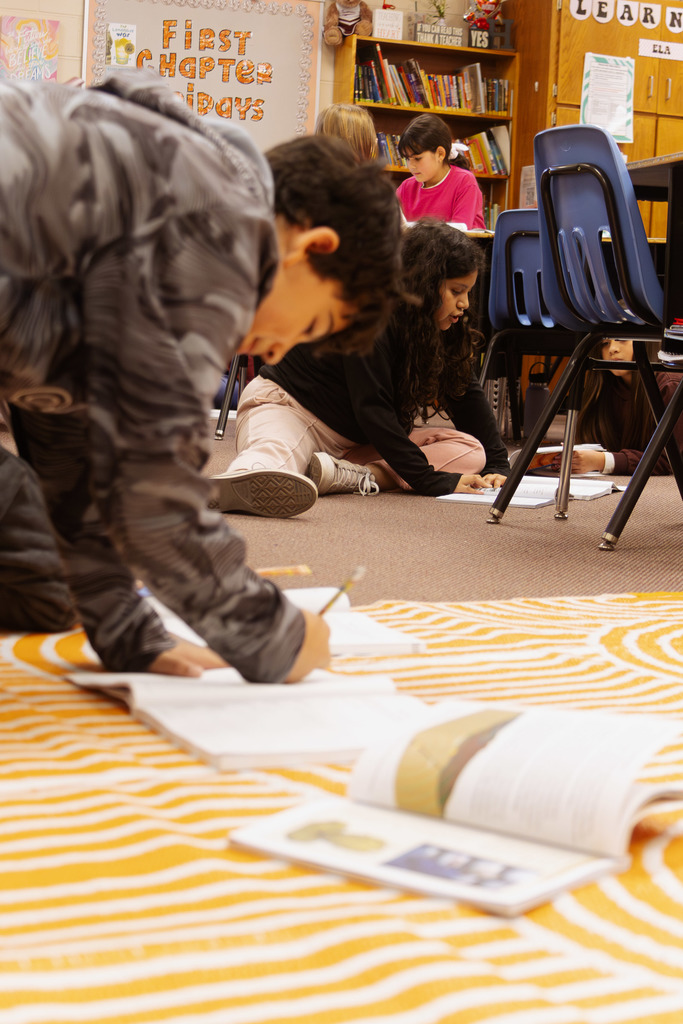 students working throughout the classroom on their assignments