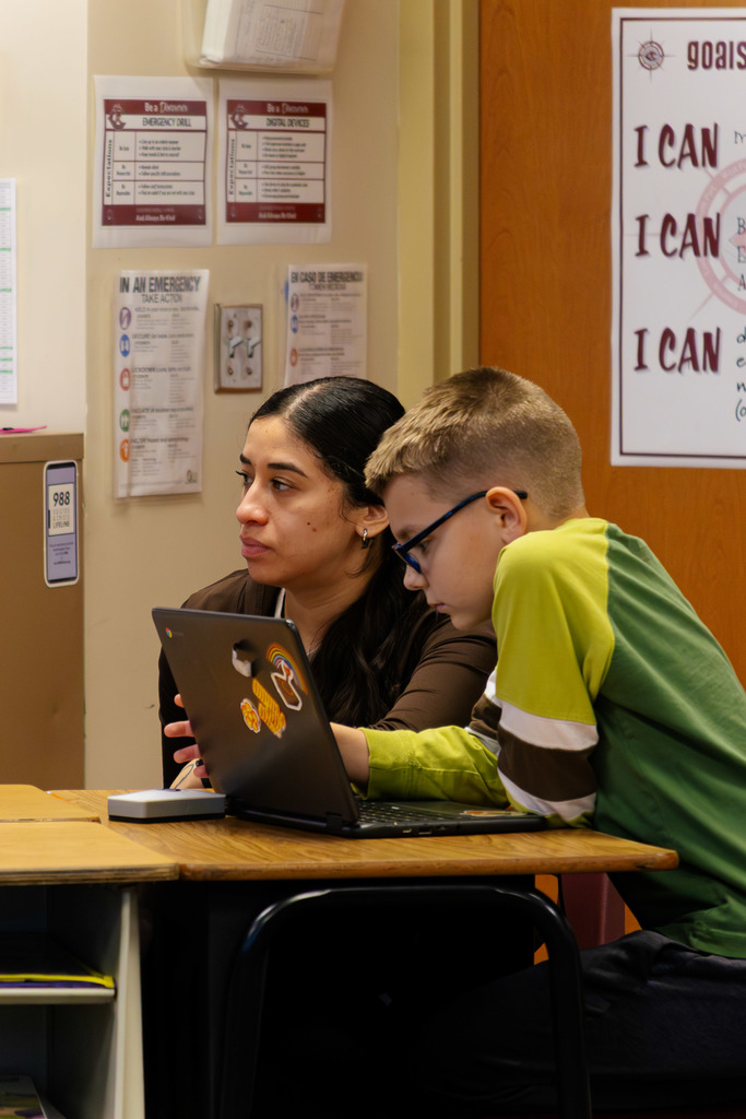 paraeducator supporting a student in the classroom