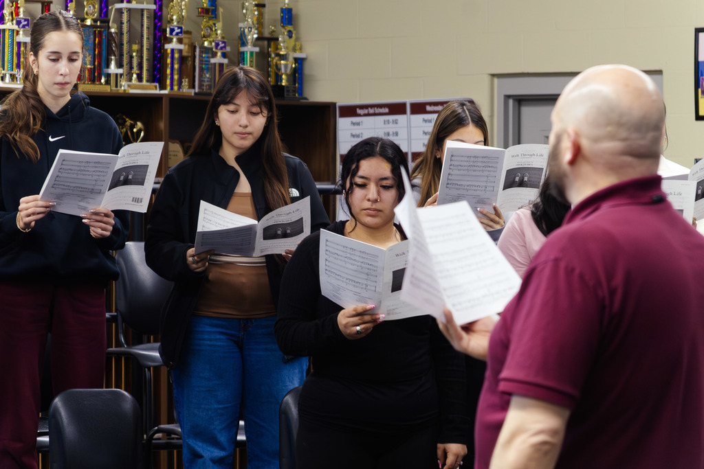 choir students hitting their notes at the direction of Mr. Ritter