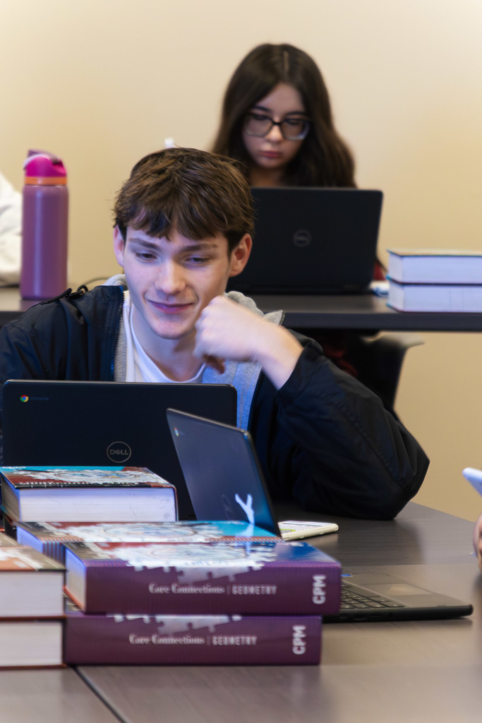 student completing an assignment in AP Algebra