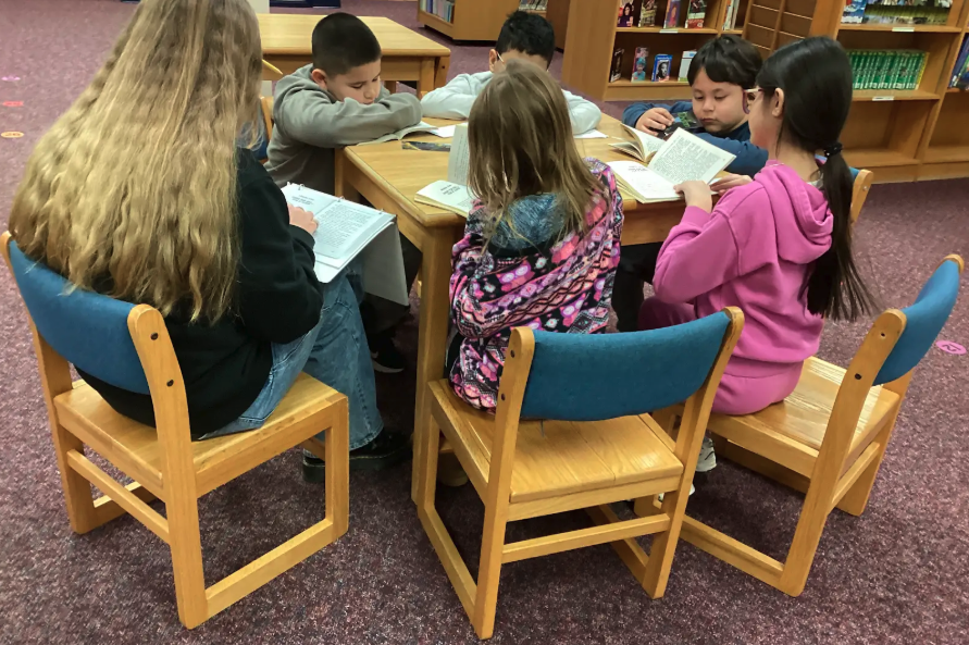 WIN students reading a chapter book