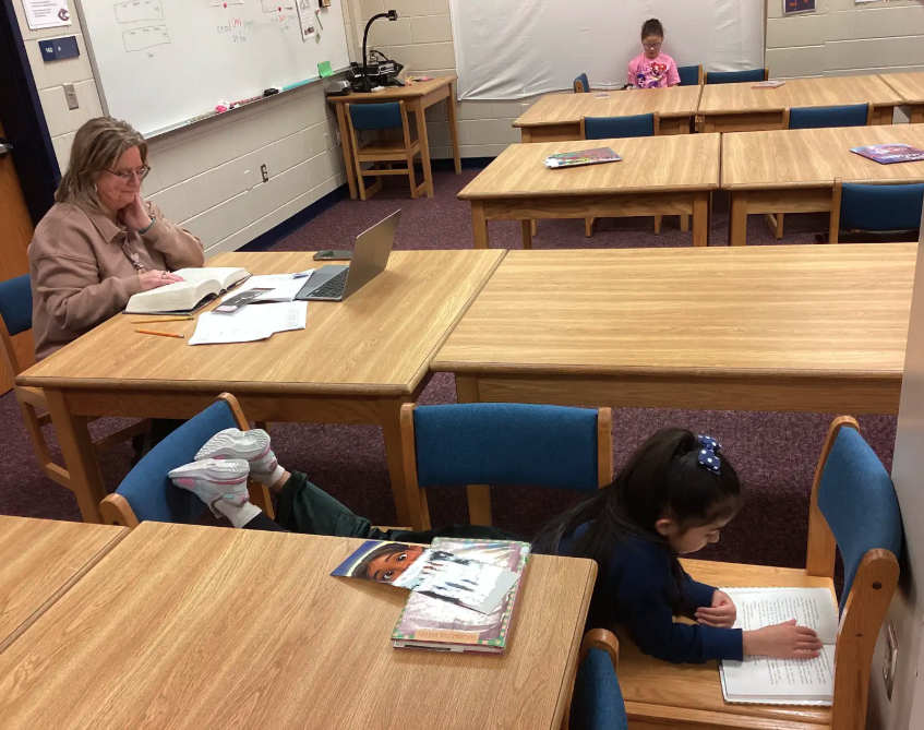 Mrs. Luchsinger and students reading for DEAR minutes