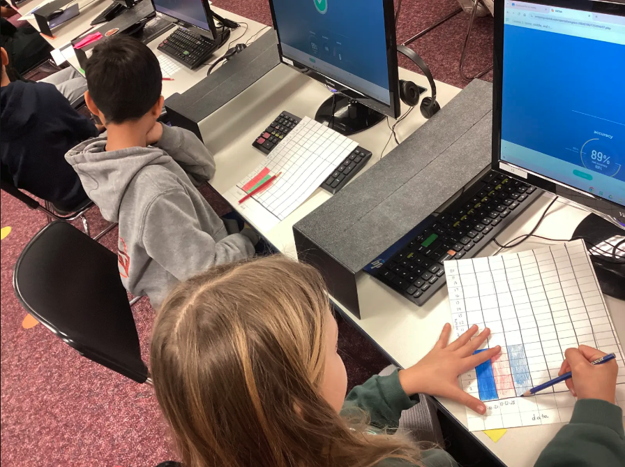 Fourth grade students charting their typing achievement