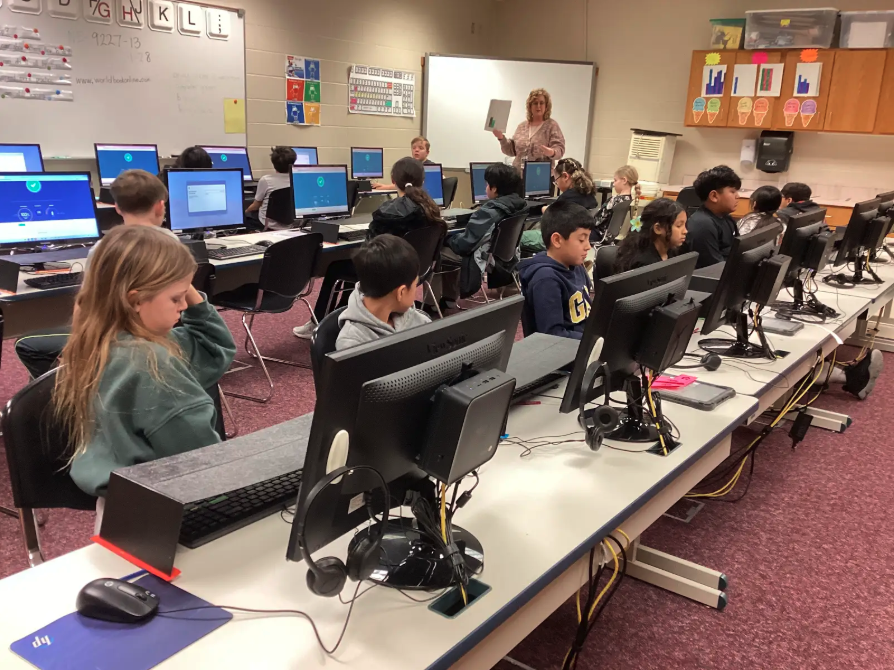 Fourth grade students typing on a computer