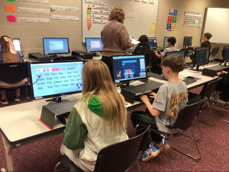 Fourth grade students typing on a computer