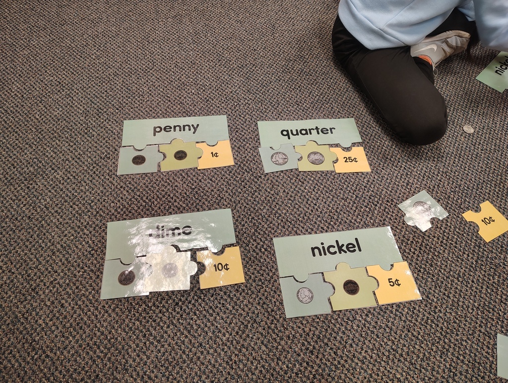 A completed puzzle activity showing penny, quarter, dime and nickel.