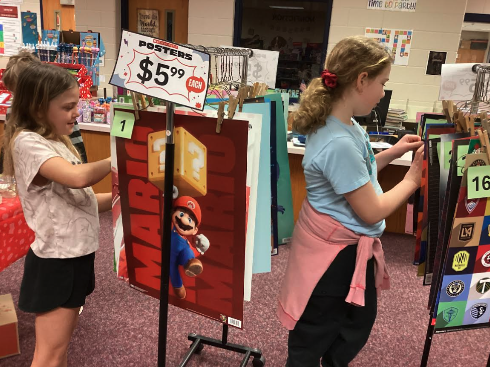 Students shopping for posters at the book fair