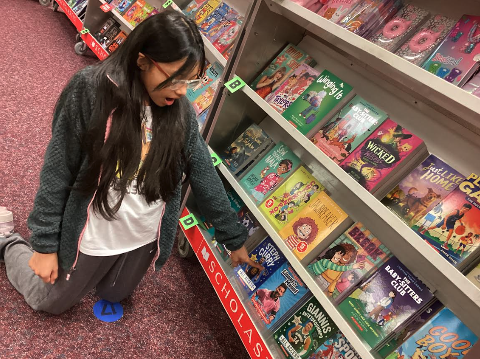 Student shopping for books at the book fair