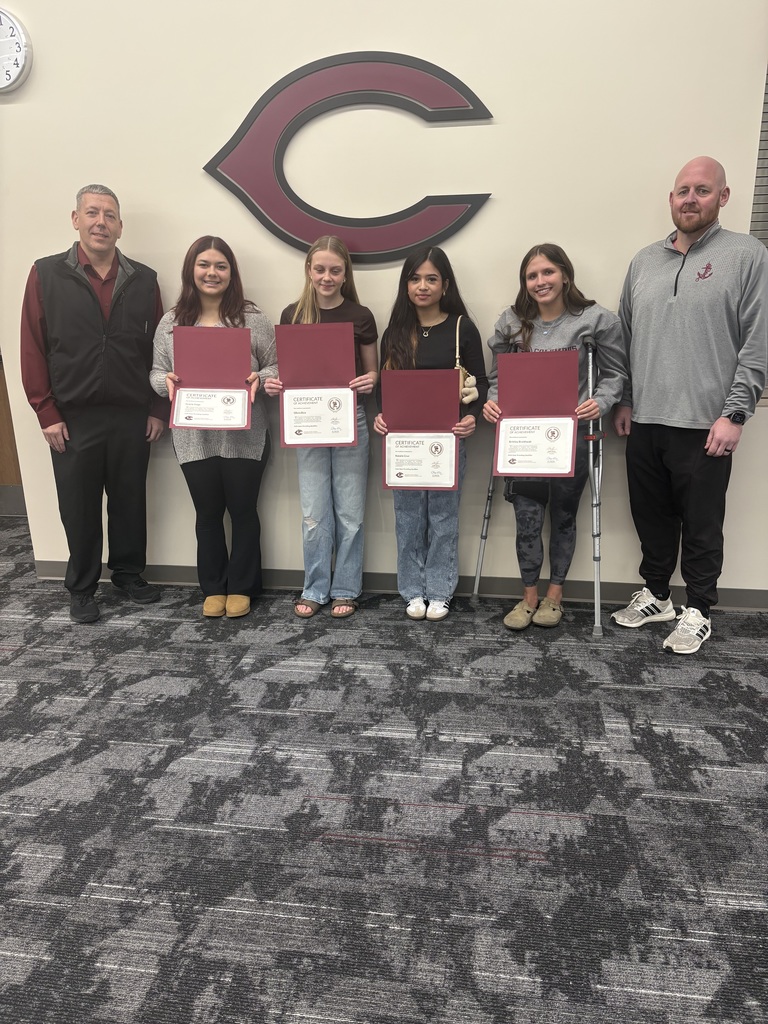 Mike Jeffryes posing for a photo with members of the CHS Girls Wrestling team and coach bice