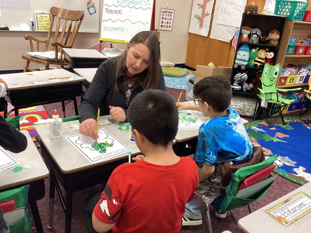 Mrs. Fisher helping students with an art project