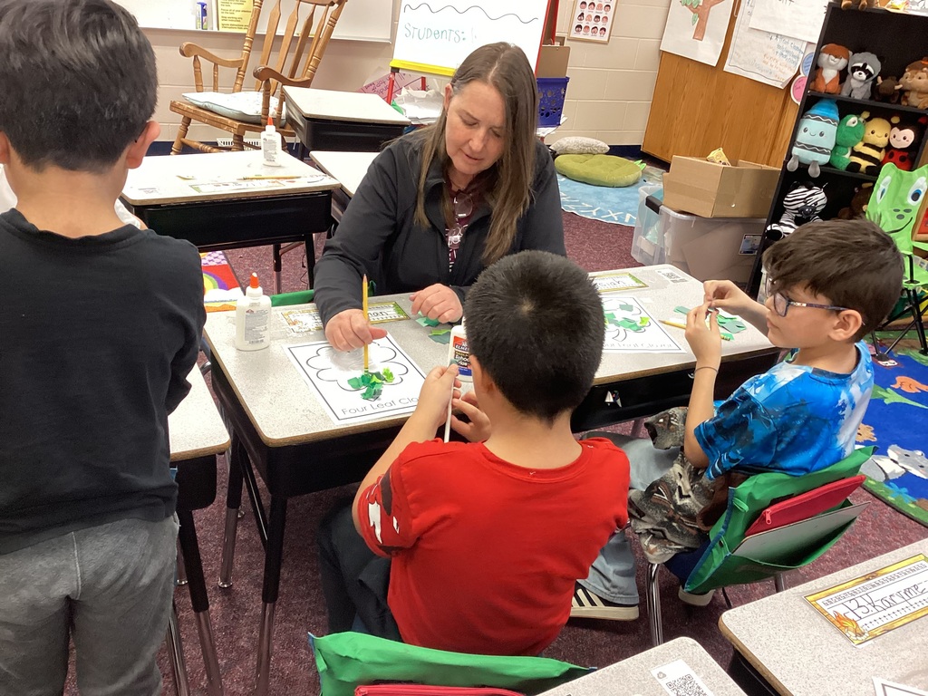 Mrs. Fisher helping students with an art project