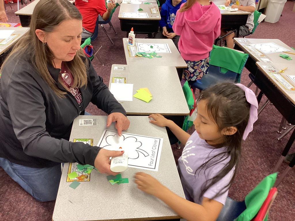 Mrs. Fisher helping students with an art project