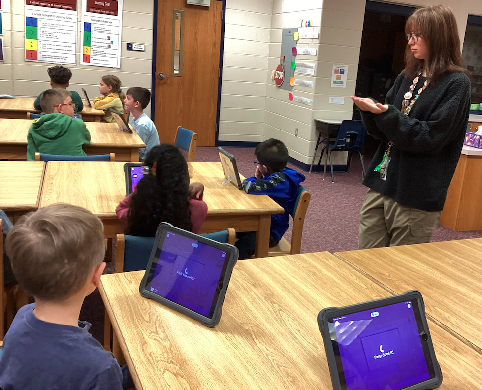 Ms. Johnson helping students in media class