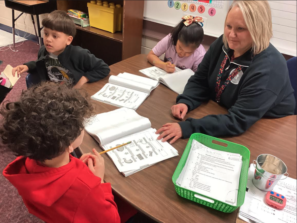 Mrs. Hardy helping second grade students