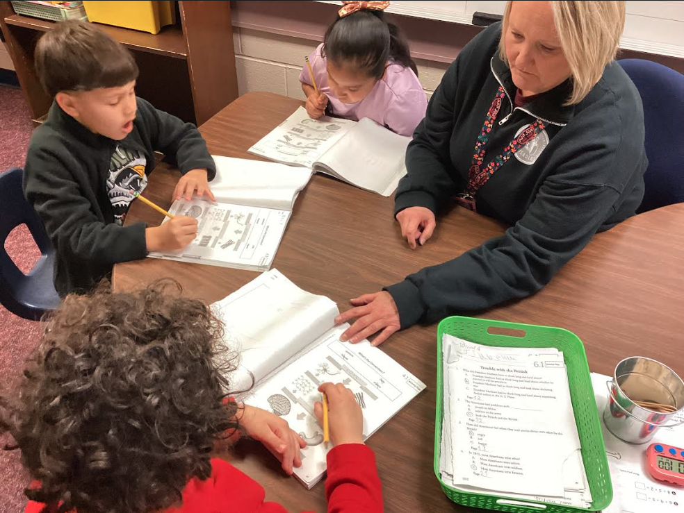 Mrs. Hardy helping second grade students