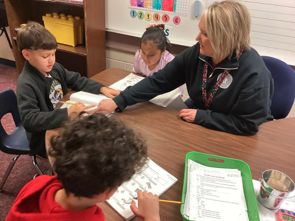 Mrs. Hardy helping second grade students
