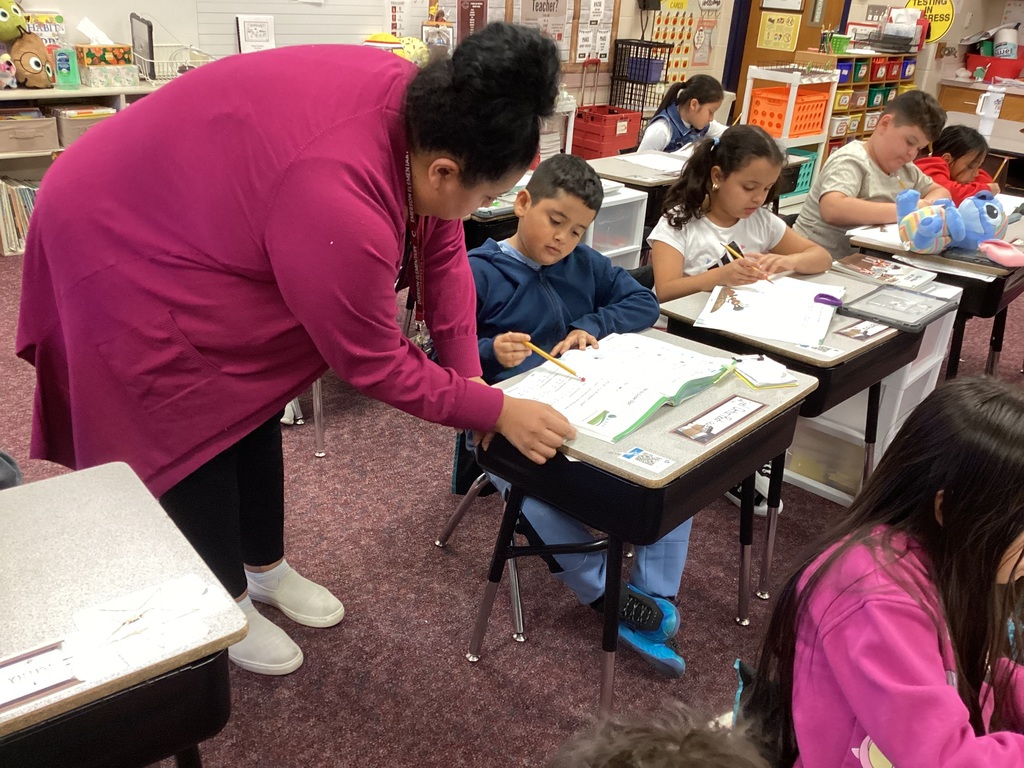 Ms. Moran helping a second grade student