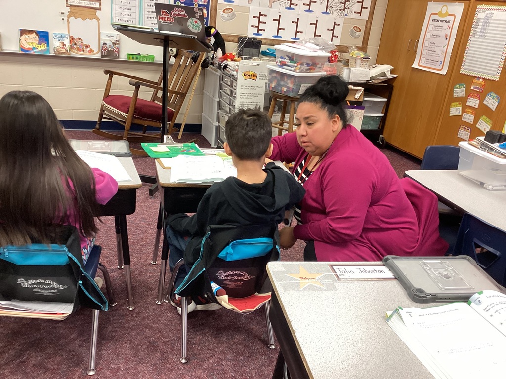 Ms. Moran helping a second grade student