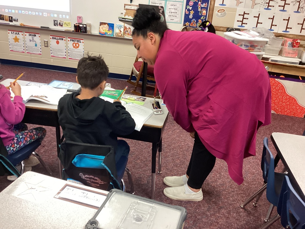 Ms. Moran helping a second grade student