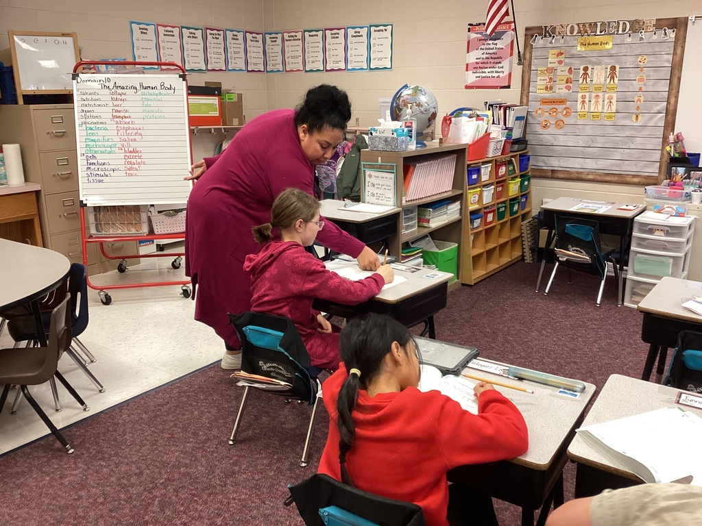 Ms. Moran helping a second grade student