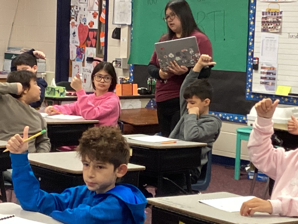 Ms. Torres helping lead a third grade art lesson