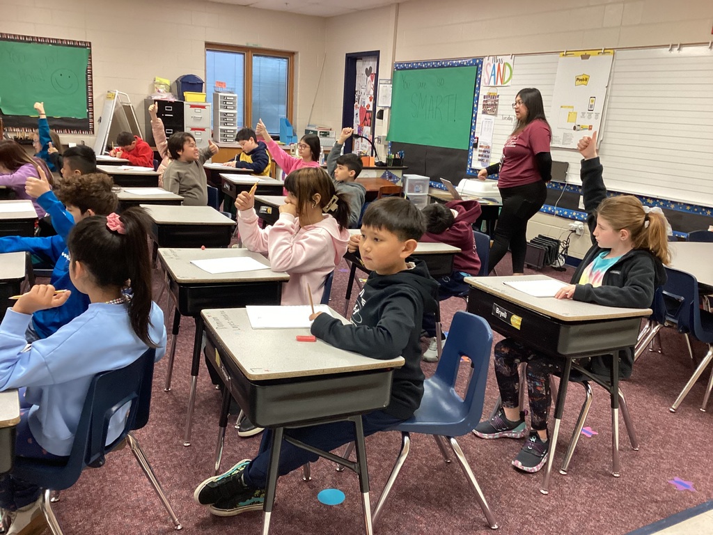 Ms. Torres helping lead a third grade art lesson