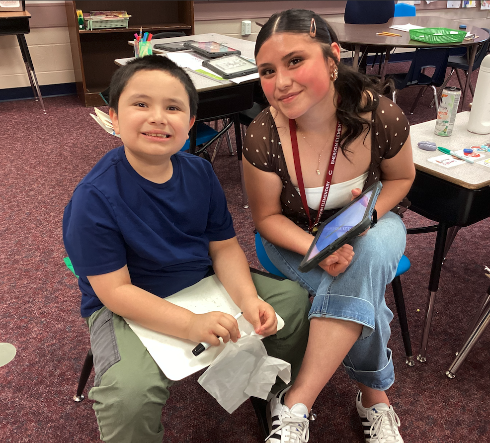 Ms. Mendoza helping a second grade student