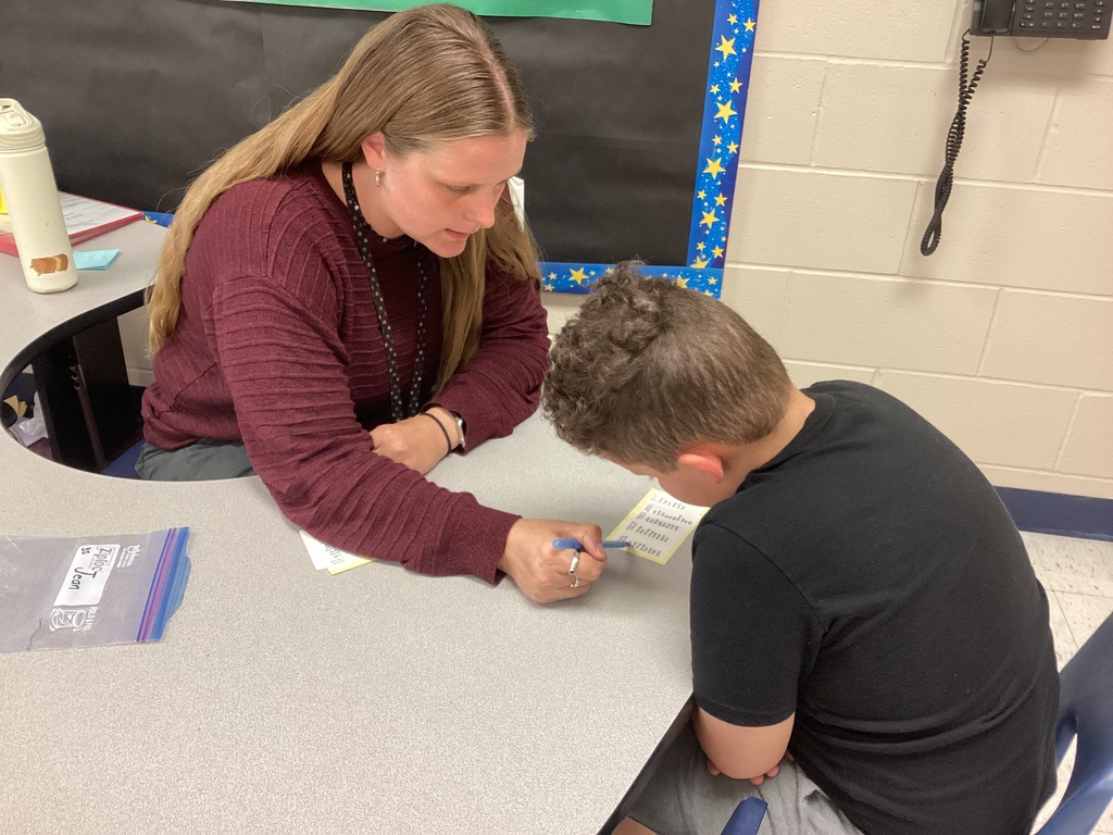 Ms. Mahoney helping a third grade student