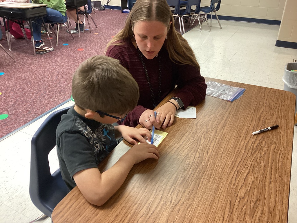Ms. Mahoney helping a third grade student