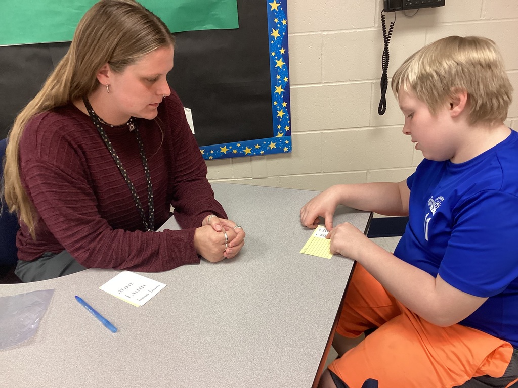 Ms. Mahoney helping a third grade student