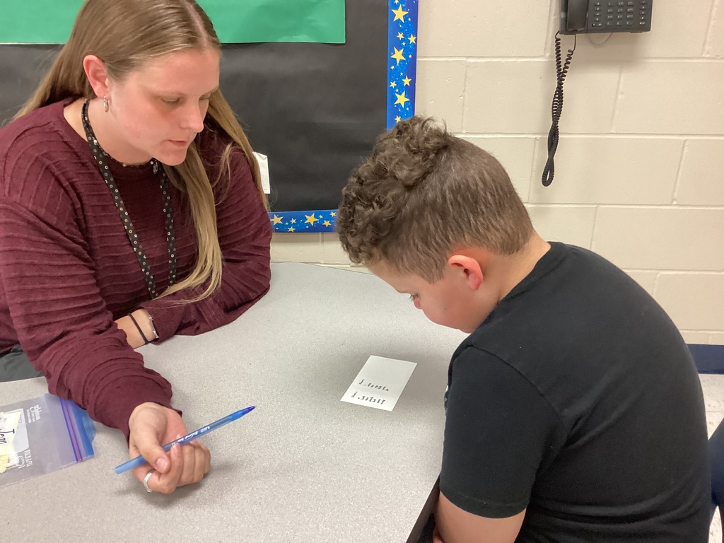 Ms. Mahoney helping a third grade student
