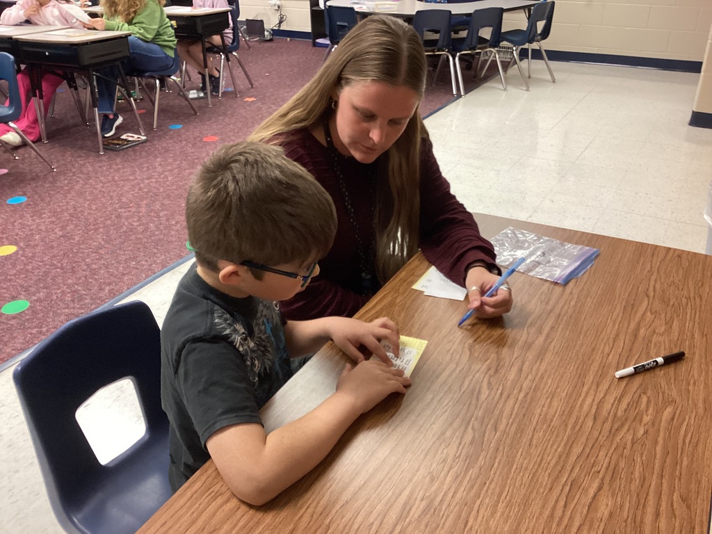 Ms. Mahoney helping a third grade student
