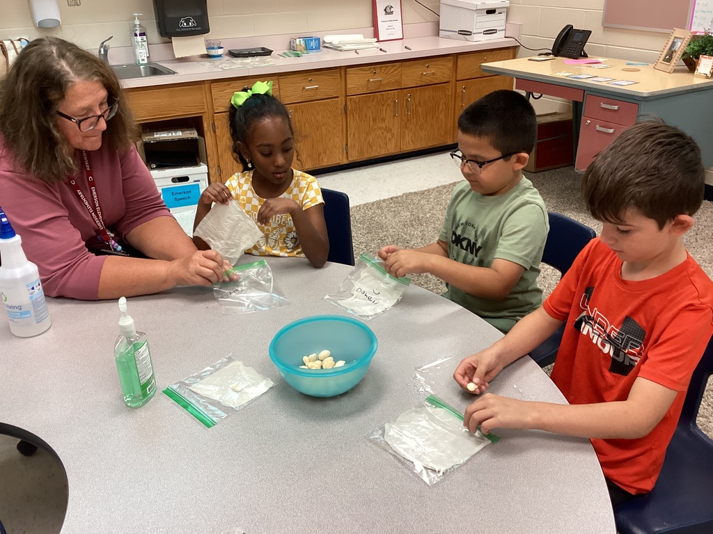 Mrs. Knerl and Mrs. Warth working with first grade students