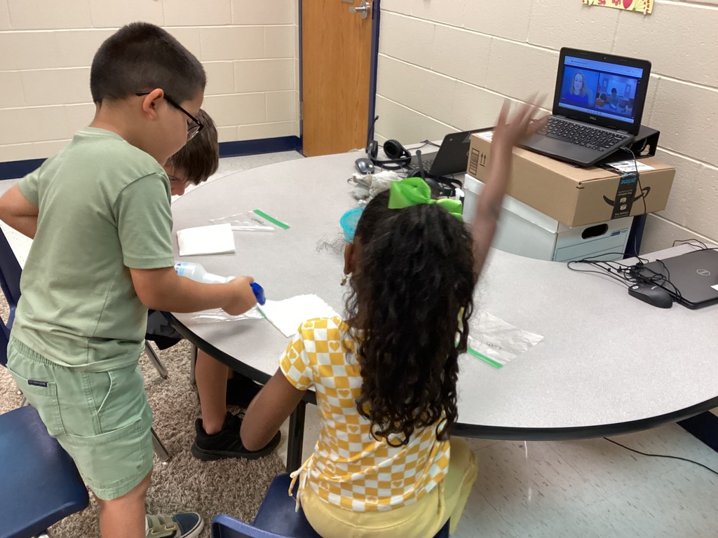 Mrs. Knerl and Mrs. Warth working with first grade students