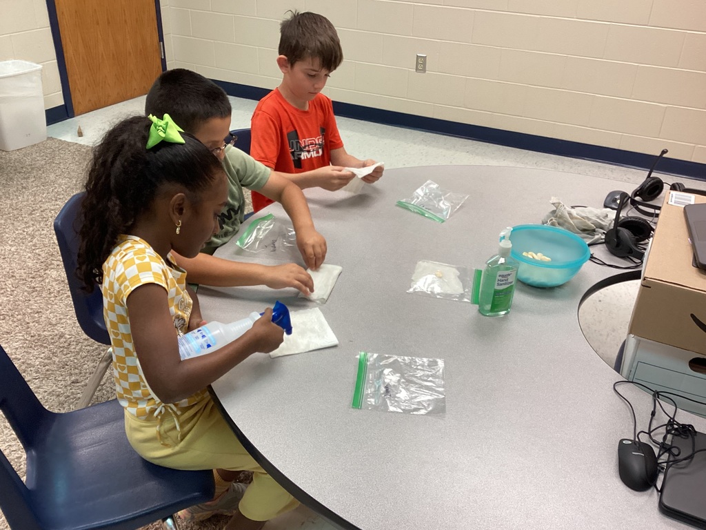 Mrs. Knerl and Mrs. Warth working with first grade students