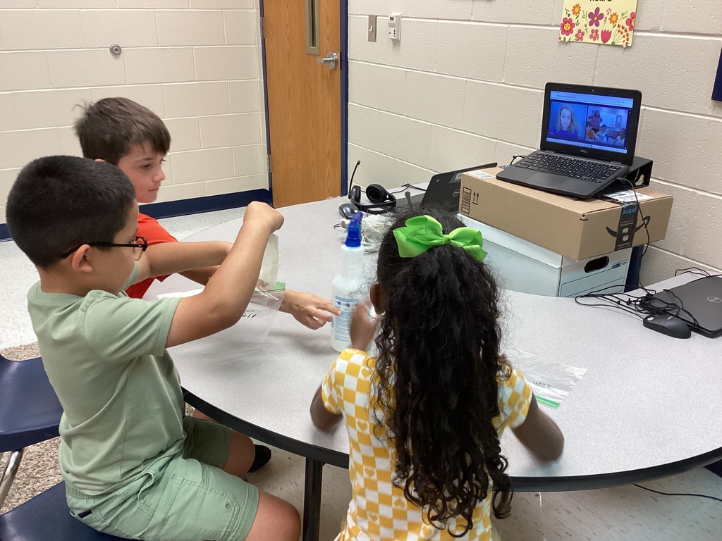 Mrs. Knerl and Mrs. Warth working with first grade students