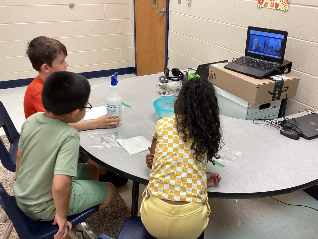 Mrs. Knerl and Mrs. Warth working with first grade students