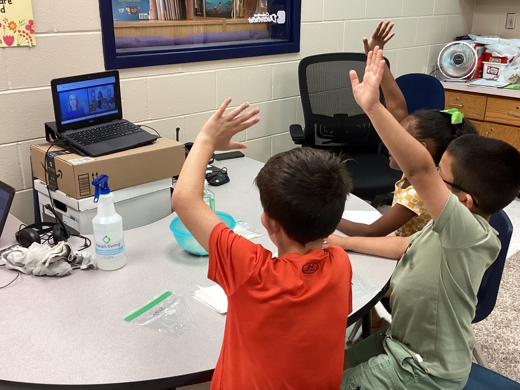 Mrs. Knerl and Mrs. Warth working with first grade students