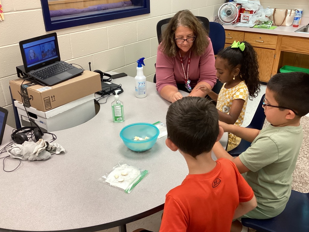 Mrs. Knerl and Mrs. Warth working with first grade students