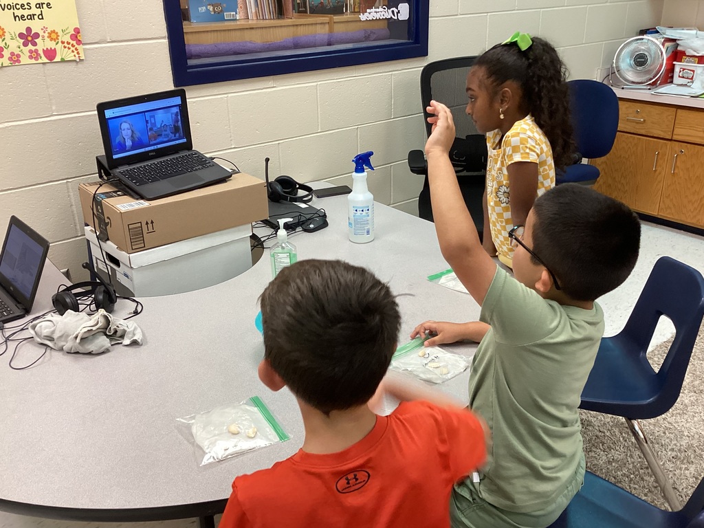 Mrs. Knerl and Mrs. Warth working with first grade students