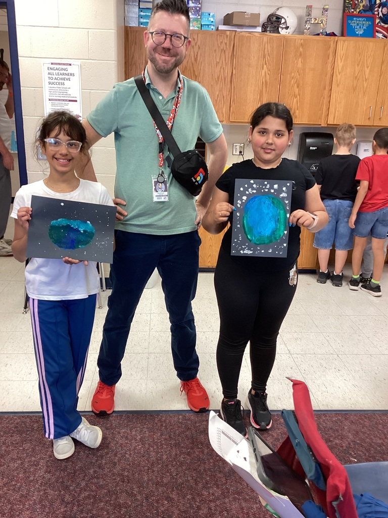 Mr. Brant with fourth graders and their art projects
