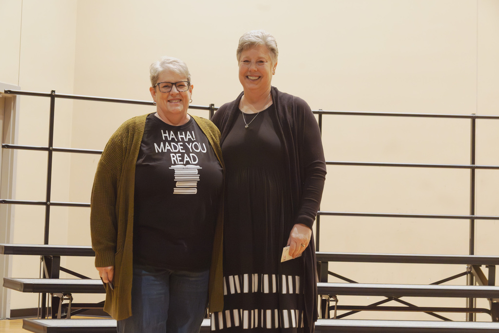 Cathy Kwapnioski and Laura Magg following their receipt of their 35 years of service pin. risers in background located at CHS